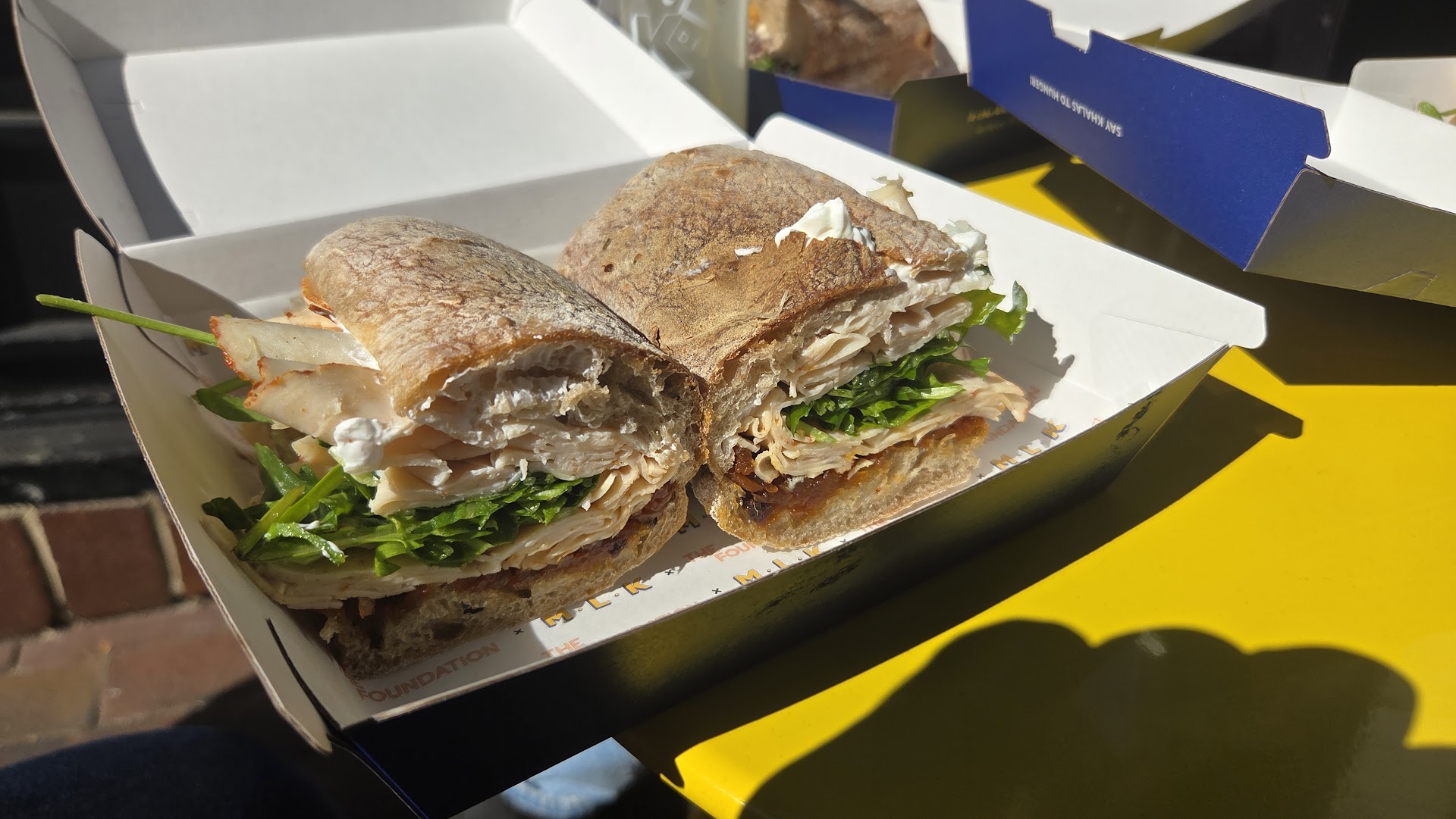 Close-up of a sandwich in an MLK Deli takeaway box